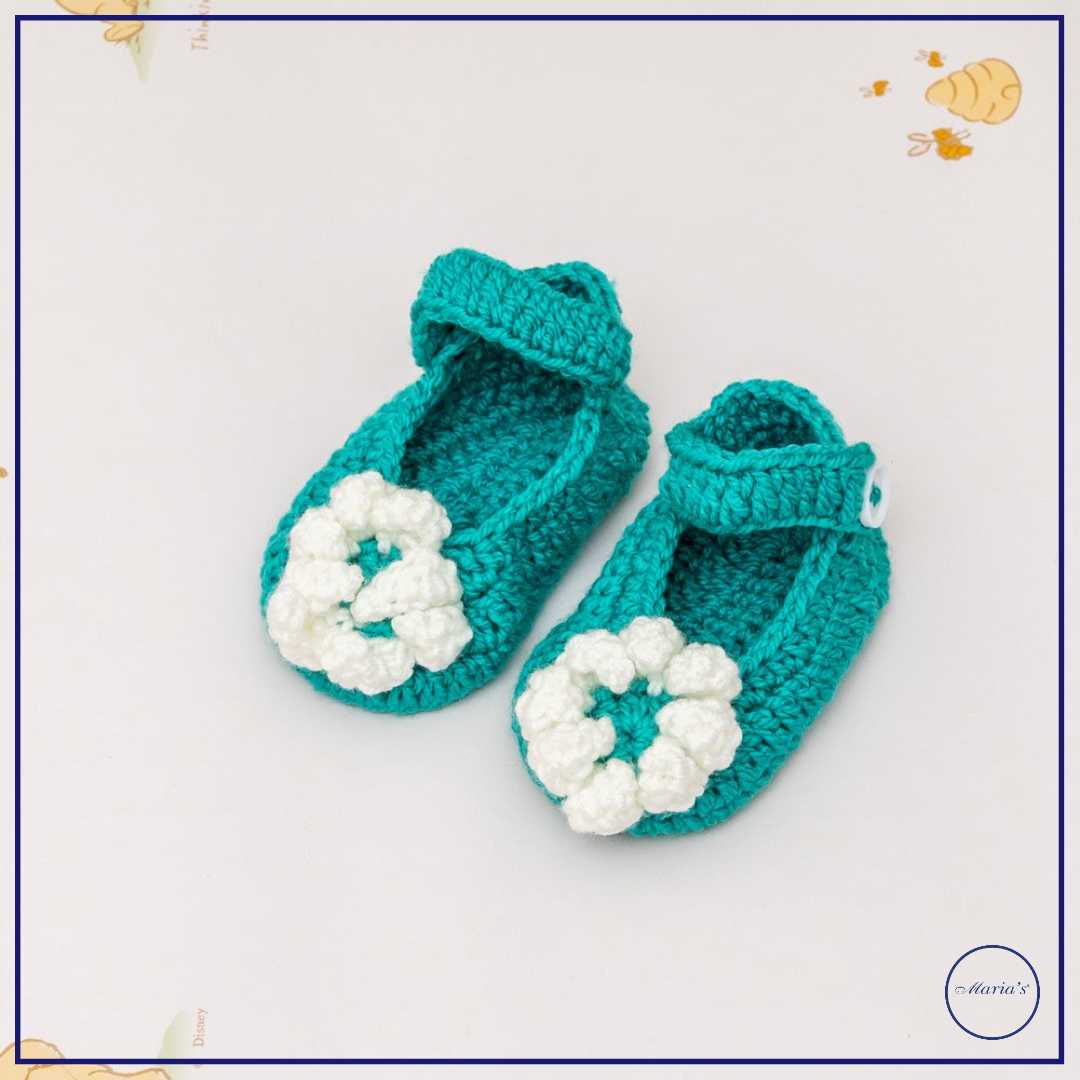 Knitted Booties With Embroidered Motive